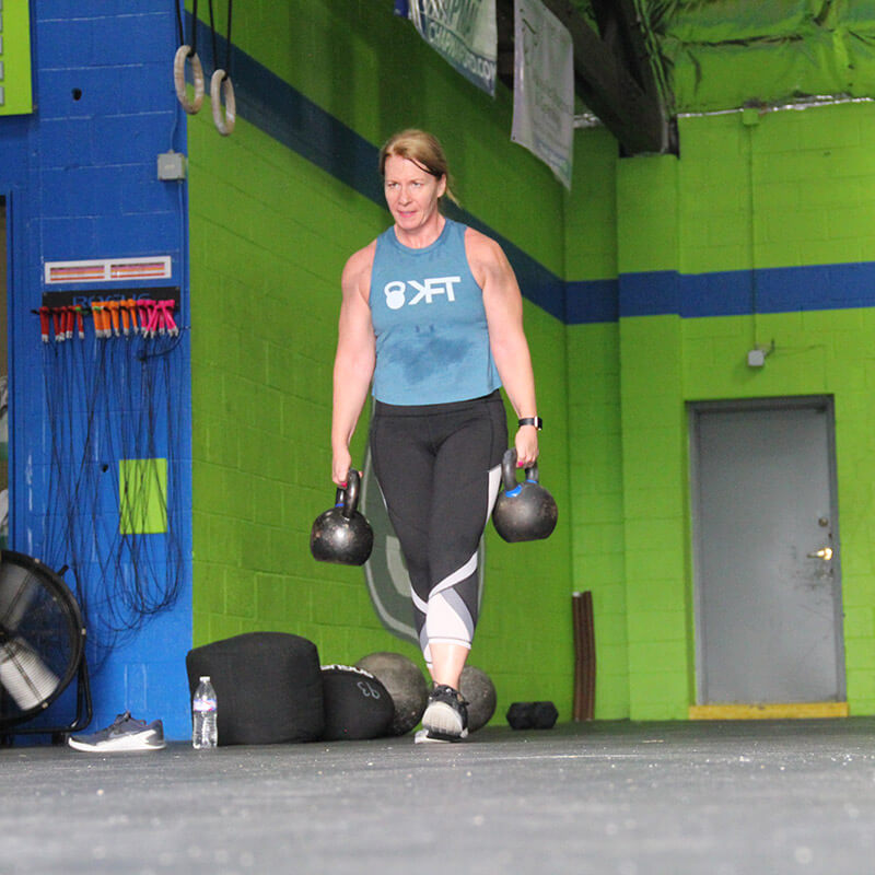 Woman carrying kettlebells