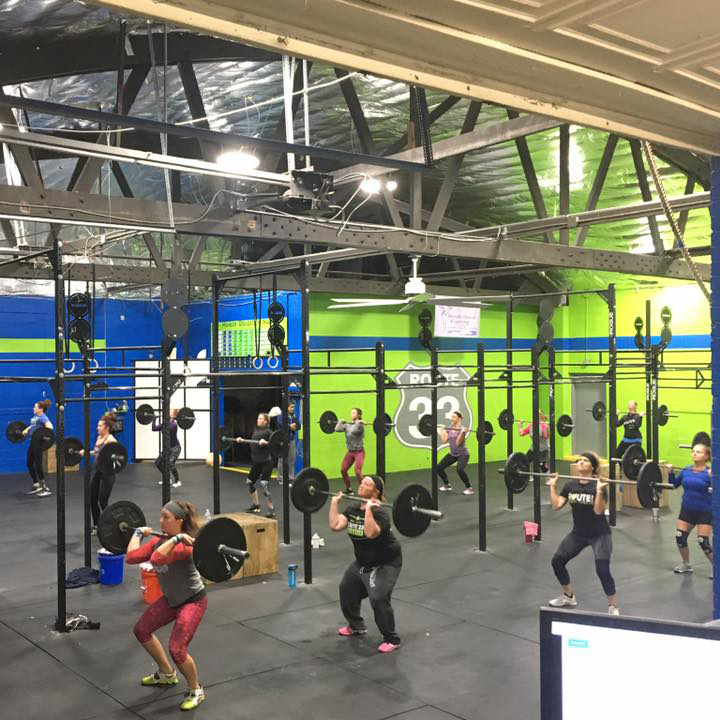 Athletes doing power cleans